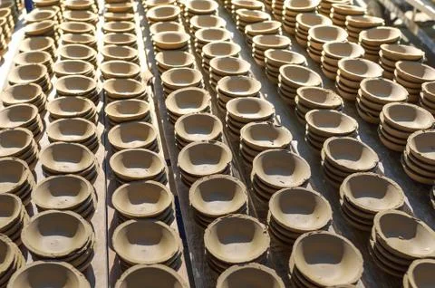 Ceramic cup in rack prepare for bring in furnace in factory Stock Photos