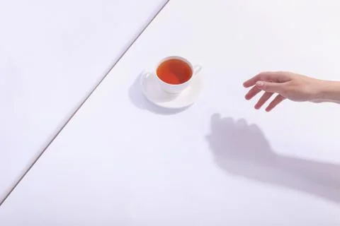 Ceramic cup with tea, on a white background. The harsh shade of the sun, the  Stock Photos