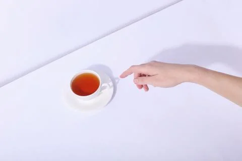 Ceramic cup with tea, on a white background. The harsh shade of the sun, the  Stock Photos