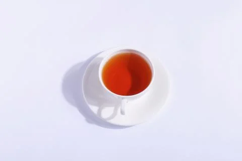 Ceramic cup with tea, on a white background. The harsh shade of the sun, the  Stock Photos