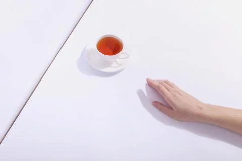 Ceramic cup with tea, on a white background. The harsh shade of the sun, the  Stock Photos