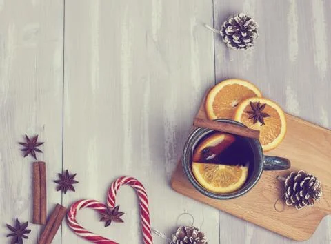 A ceramic cup of warming tea with cinnamon and orange on a rustic white table Stock Photos