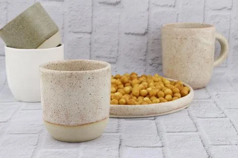 Ceramic cups in different sizes and colors. Stock Photos