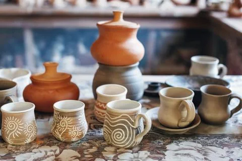 Ceramic cups with patterns and ceramic pots on the shelf Stock Photos