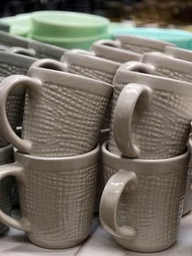 Ceramic cups placed on store shelving forming a practical tableware selecti.. Stock Photos