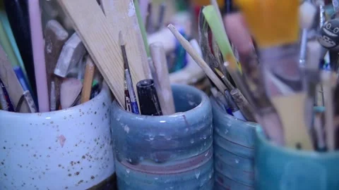 Ceramic cups with various tools blurry close-up in the workshop Видео 148265074
