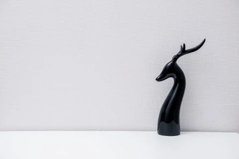 Ceramic deer figurine on light background Stock Photos