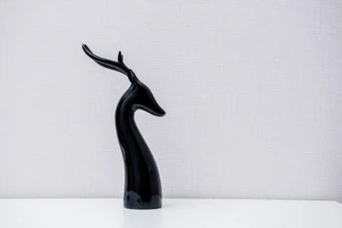 Ceramic deer figurine on light background Stock Photos