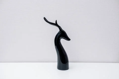 Ceramic deer figurine on light background Stock Photos