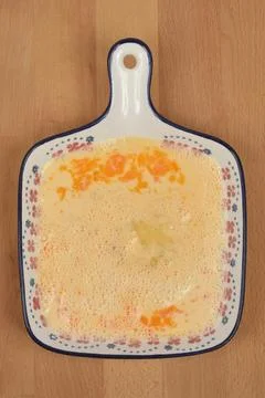 Ceramic dish with beaten eggs Stock Photos