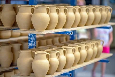 Ceramic dishware in pottery workshop Ceramic dishware arranged on shelf in... Stock Photos