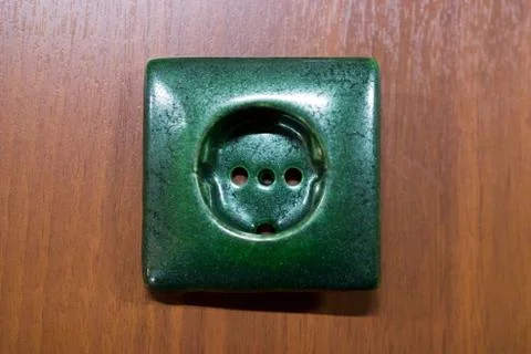 Ceramic electric green socket made with a plaster mold. double firing, icing. Stock Photos