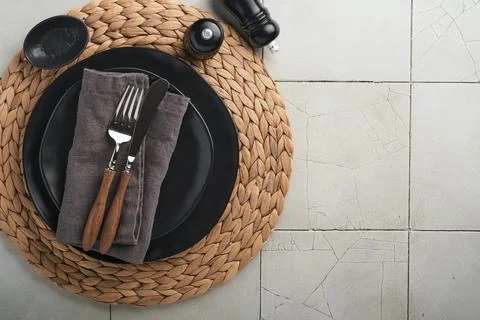 Ceramic empty black plate, silverware and linen kitchen towel napkin on old c Stock Photos