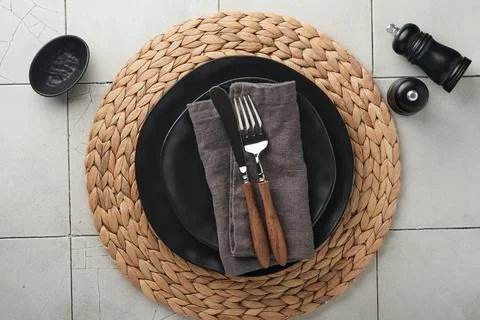 Ceramic empty black plate, silverware and linen kitchen towel napkin on old c Stock Photos