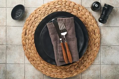 Ceramic empty black plate, silverware and linen kitchen towel napkin on old c Stock Photos