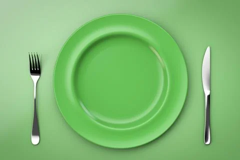 Ceramic empty plate. Knife and fork. Green style. Top view. Stock Photos