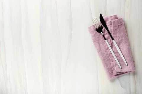 Ceramic empty white plate and pink linen kitchen towel napkin on old ceramic  Stock Photos