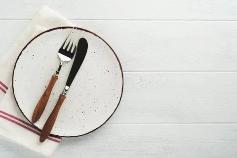 Ceramic empty white plate. Rustic vintage set of white plate, wooden spoon on Stock Photos