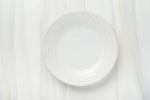 Ceramic empty white plate. Rustic vintage set of white plate, wooden spoon on Stock Photos