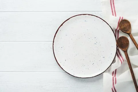 Ceramic empty white plate. Rustic vintage set of white plate, wooden spoon on Stock Photos