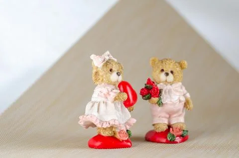 Ceramic figures on a light background. Focus on the bear girl figurine. Teddy Stock Photos