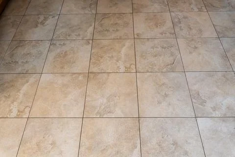 Ceramic floor tile pattern in beige and brown tones with natural stone texture, Stock Photos