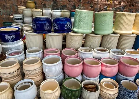 Ceramic garden pots with decorative patterns arranged in retail display setti Stock Photos