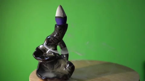 Ceramic holder with smoldering incense cone on top. Heavy backflow smoke Stock Footage 222836565