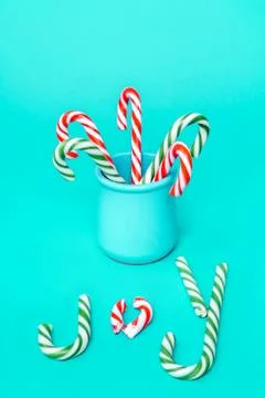 Ceramic jar with candy canes of red and green color and spelling word Joy Stock Photos