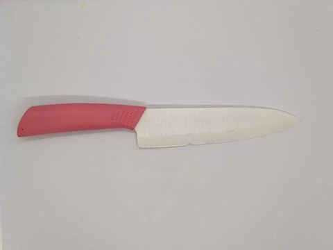 Ceramic kitchen knife. one ceramic kitchen knife with pink handle on white ba Stock Photos