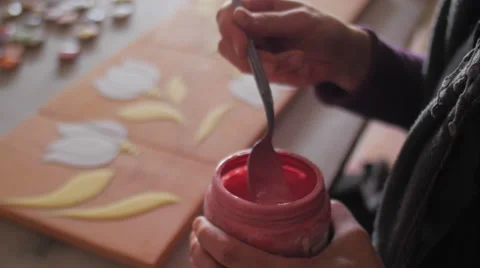Ceramic maker mixing color enamel in plastic jar Video stock 61949011