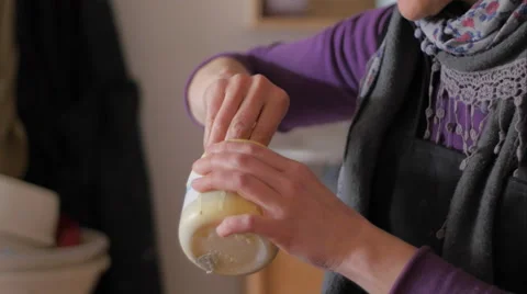 Ceramic maker mixing color enamel in plastic jar and preparing plastic bulb Stock Footage 61951968