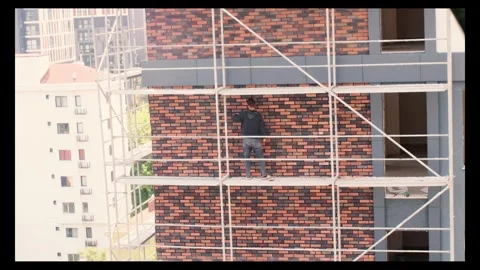 Ceramic master laying ceramic tiles the facade of building with ceramics Stock Footage 296388590