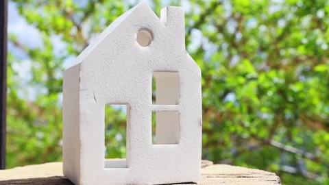 Ceramic miniature white house on a background with natural elements close-up. Stock Footage 196115064
