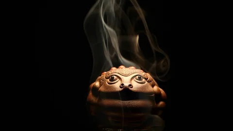 Ceramic money toad smoke dark background hd footage Stock Footage 100357533
