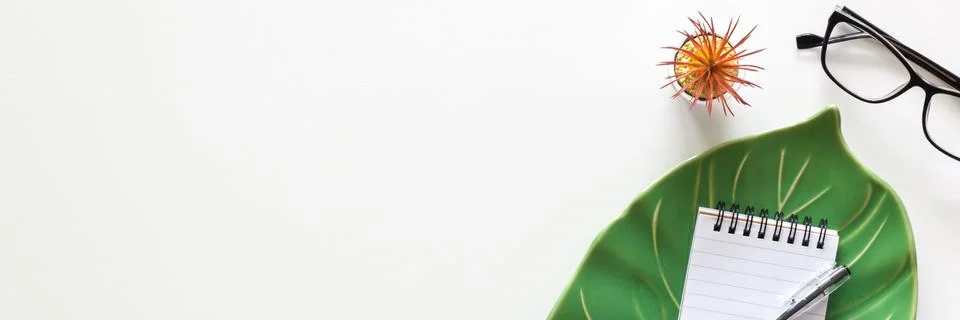 Ceramic monstera leaf with notebook. View from above. Copy space. Stock Photos