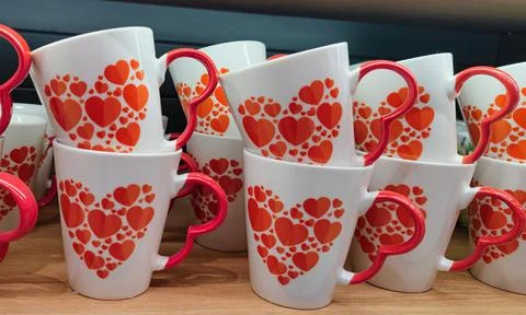 Ceramic mug, white glass with a pattern, heart pattern as a gift to a loved one Stock Photos