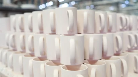 Ceramic mugs are stacked precisely in a large warehouse, showcasing the massive Stock Footage 327422005