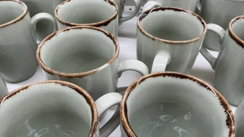 Ceramic mugs arranged in rows create a pattern of rustic kitchenware, ideal.. Stock Footage 331147346