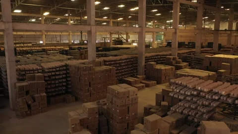 Ceramic mugs organized on drying racks alongside large stacks of cardboard Stock Footage 327609448