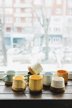 Ceramic mugs on windowsill Stock-Fotos