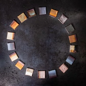 Ceramic multicolor square tiles placed as a wreath or circle, geometric textu Stock Photos