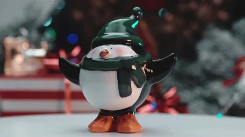 Ceramic penguin toy on the background of New Year's gifts. Stock Footage 145367763