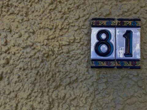 Ceramic plaques placed on the wall with the number eighty-one Stock Photos