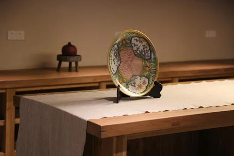 A ceramic plate with chinese patterns is placed on the table in front of yo.. Stock Photos