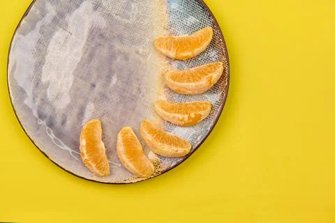 Ceramic plate with orange slices on an empty background Stock Photos