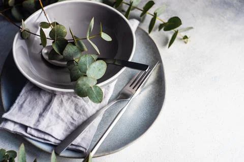 Ceramic plates place setting with eucalyptus stems Stock Photos