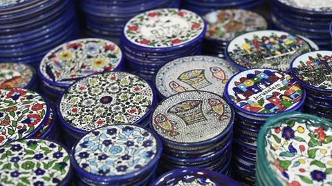 Ceramic plates with traditional national pattern lies on stall in market. Stock Footage 183990470