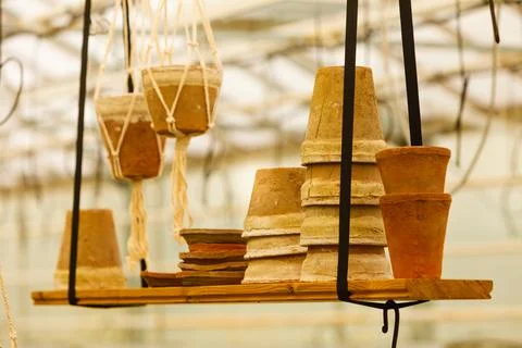 Ceramic pots on shelf hung from ceiling Stock Photos