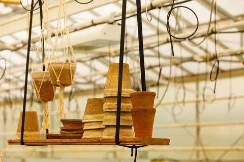 Ceramic pots on shelf hung from ceiling Stock Photos